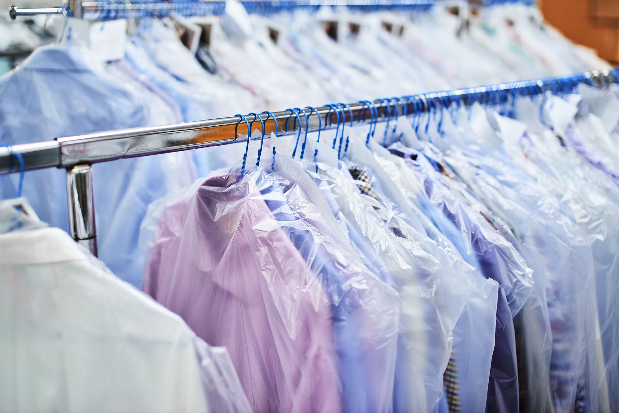 Dry cleaned shirts on hangers in a dry cleaning business.