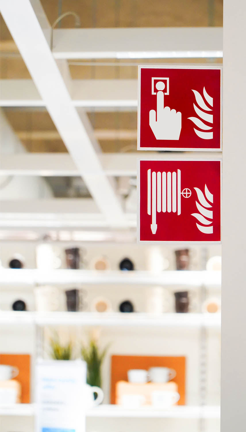 Photo showing fire safety signage indicating hose and call point locations