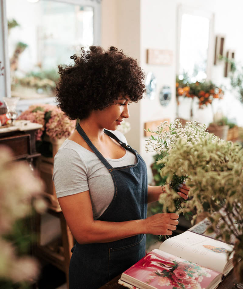 florist putting together a bunch of flowers