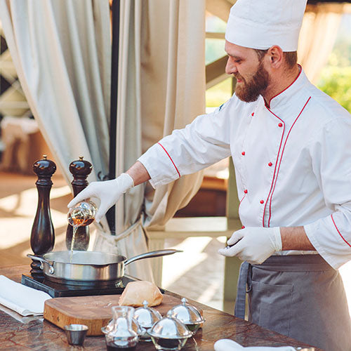 A chef prepares food for corporate event guests.