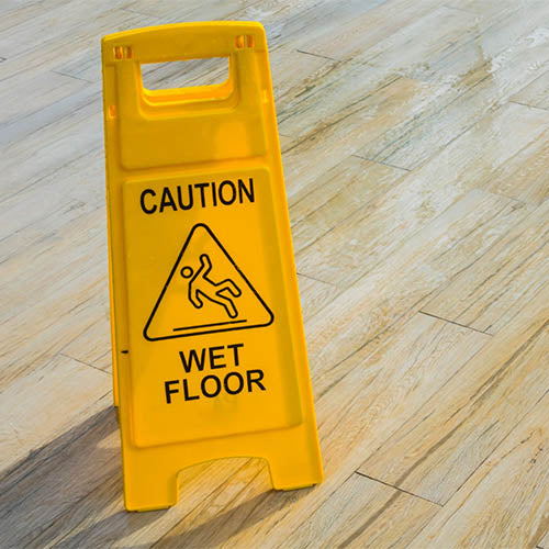 A wet floor sign on a tea room shop floor.