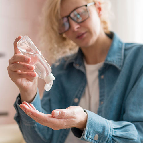 A woman using hand sanitiser in her mobile coffee shop.