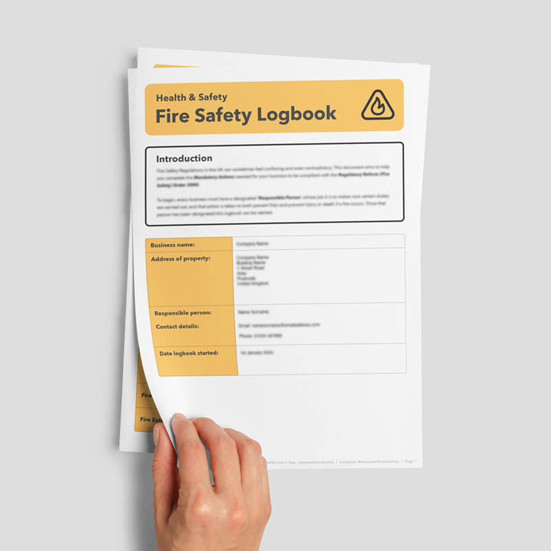 Hand flicking through fire safety log book template.