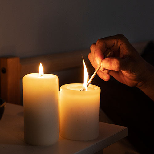 Hand lighting candles in a holiday rental Airbnb property.