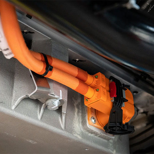 High voltage cables under an electric hybrid vehicle in for bodywork repair.