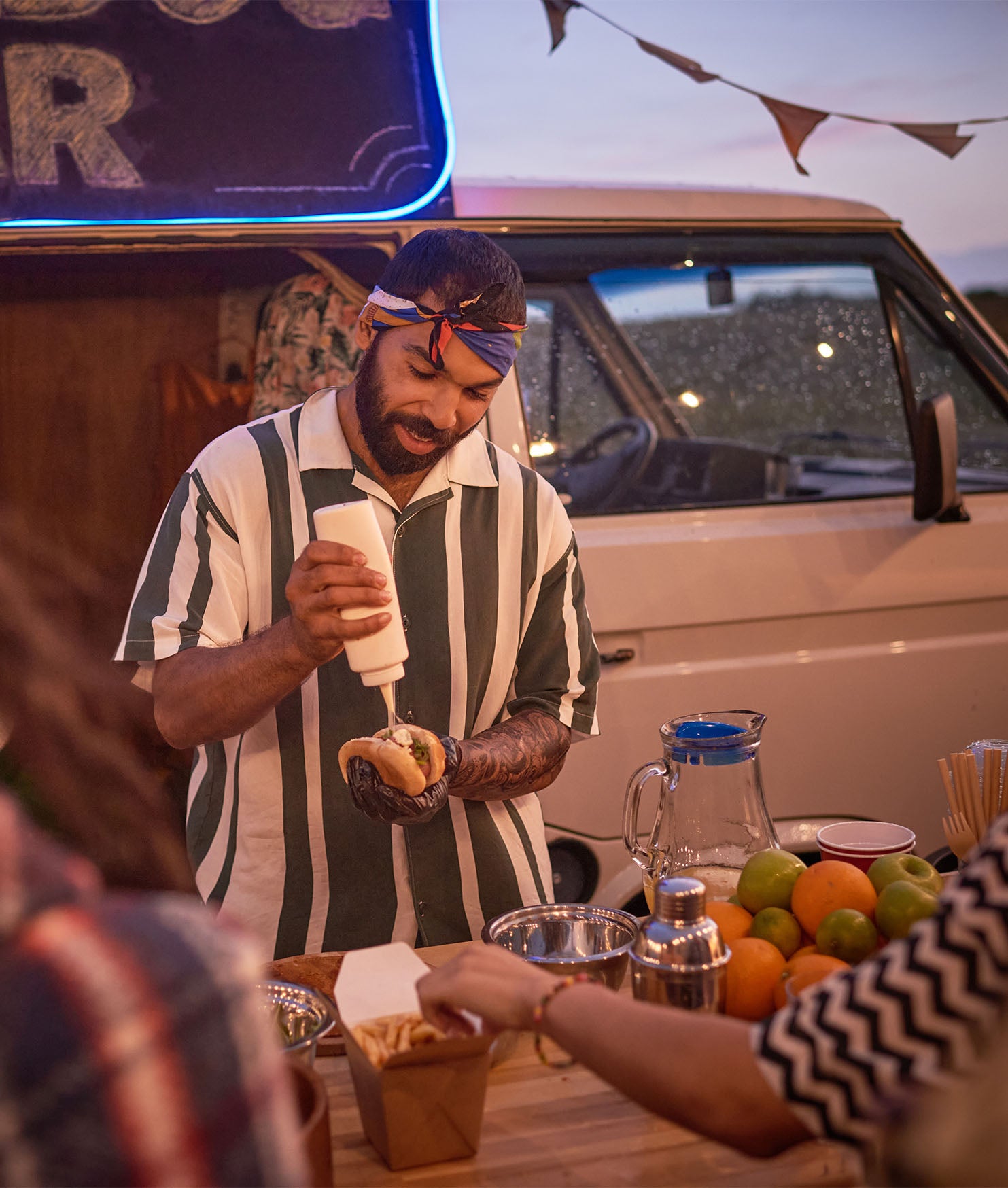 Mobile food seller preparing hot dog people.