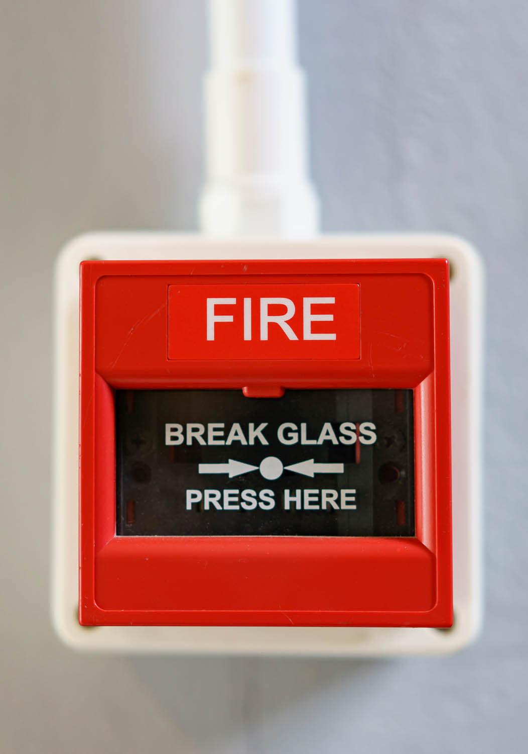 A red fire call point with break glass wording