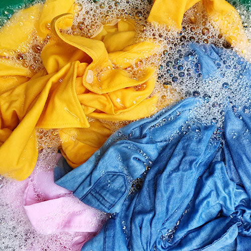Wet clothing being washed in a washing machine.