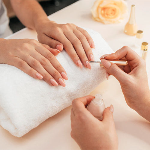 Manicurist performing a manicure.