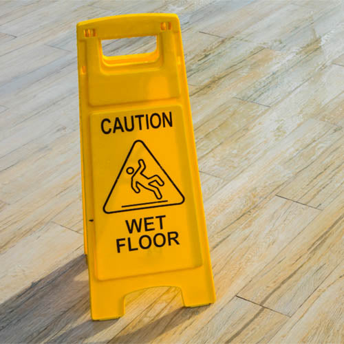 Wet floor hazard sign in office environment