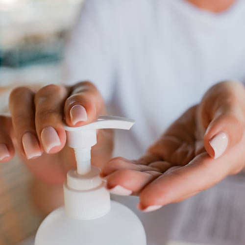 woman applying hand gel to her hands